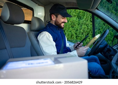 Delivery Man Driving His Van With Packages On The Front Seat.