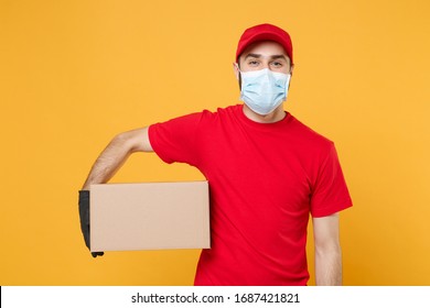 Delivery man employee in red cap blank t-shirt uniform face mask gloves hold empty cardboard box isolated on yellow background studio Service quarantine pandemic coronavirus virus 2019-ncov concept - Shutterstock ID 1687421821
