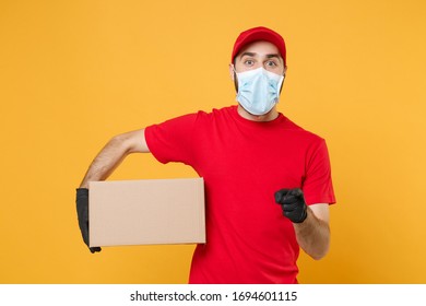 Delivery man employee in red cap blank t-shirt uniform face mask gloves hold empty cardboard box isolated on yellow background studio Service quarantine pandemic coronavirus virus 2019-ncov concept - Shutterstock ID 1694601115