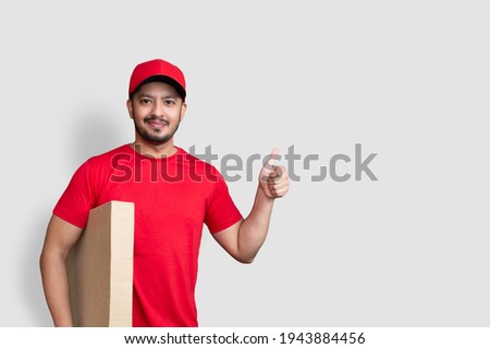 Delivery man employee in red cap blank t-shirt thumbsup uniform 