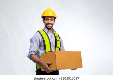 Delivery man employee in yellow hard hat hold cardboard box isolated on white background. Delivery man holding cardboard boxes. Smiling delivery man standing on white background - Powered by Shutterstock