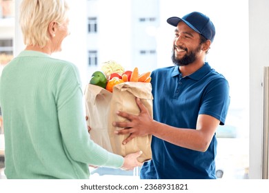 Delivery man, food and smile for customer, groceries and fresh produce from online shopping. Happy courier, supermarket discount and deal from supply chain, distribution with front door service. - Powered by Shutterstock