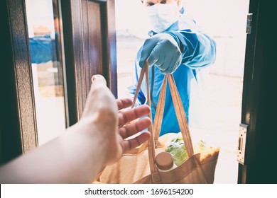 The Delivery Man Gives The Bag From Grocery Store To The Woman To Her Home