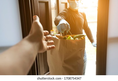 The Delivery Man Gives The Bag From Grocery Store To The Woman To Her Home