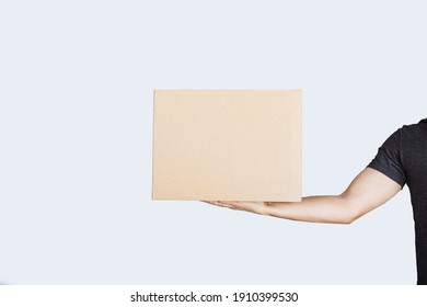 Delivery Man Hand Holding Package Box Isolated On White Background. Courier Delivering Package Express Delivery Service.