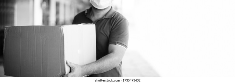 Delivery Man Holding Cardboard Box Wearing Medical Face Mask.Logistic Delivery Transport.Online Shopping And Express Delivery.Donate Food Box, Delivery Business, Lock Down,People, Covid-19 Coronavirus