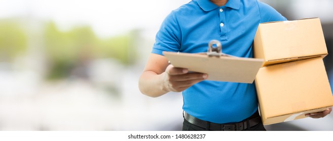 Delivery man holding cardboard boxes / copy space - Shutterstock ID 1480628237