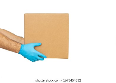 Delivery man holding cardboard boxes in rubber gloves / copy space. Fast and free Delivery transport . Online shopping and Express delivery 