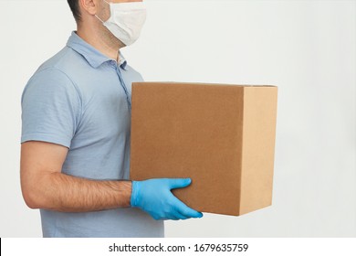 Delivery man holding cardboard boxes in medical rubber gloves and mask. copy space. Fast and free Delivery transport . Online shopping and Express delivery . Quarantine  - Shutterstock ID 1679635759