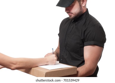 Delivery man holding a parcel while woman putting signature in clipboar.  Courier service concept