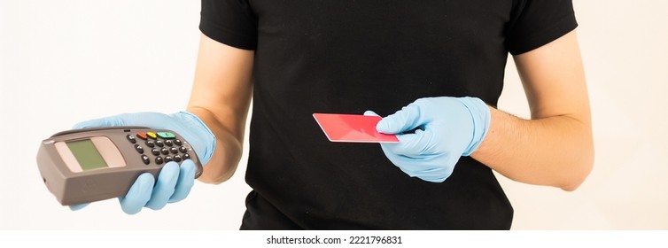 Delivery Man Holds Bank Payment Terminal To Process Acquire Credit Card Payments. Employee In Cap T-shirt Working Courier. Service Concept