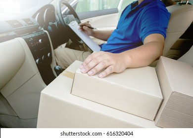 Delivery man inside the car checking list on clipboard  - Powered by Shutterstock