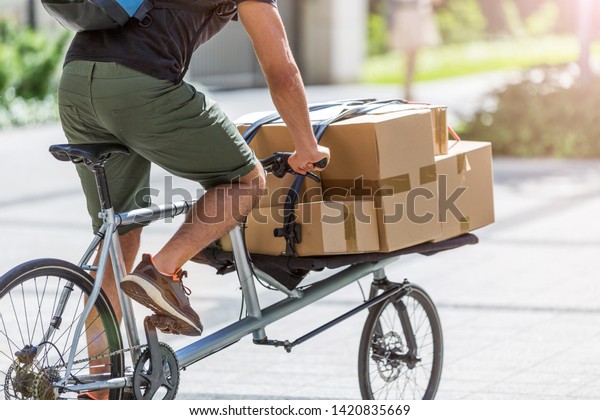 Delivery man on a cargo\
bike