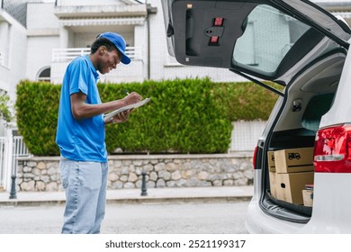 A delivery man organizing packages in his car, preparing for deliveries. Concept of logistics and efficient parcel service. - Powered by Shutterstock