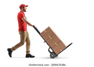 Delivery man pushing a hand truck with cardboard boxes isolated on white background