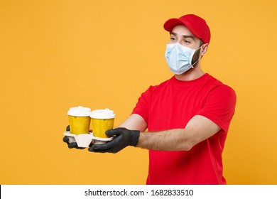 Delivery Man In Red Cap Blank T-shirt Uniform Mask Gloves Isolated On Yellow Background Studio Guy Employee Hold Takeaway Cup Of Coffee Service Quarantine Pandemic Coronavirus Virus 2019-ncov Concept