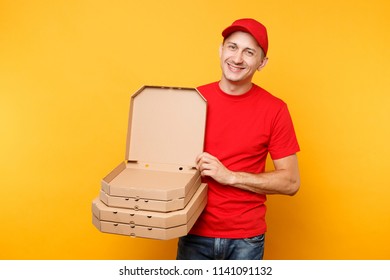 Delivery man in red cap, t-shirt giving food order pizza boxes isolated on yellow background. Male employee pizzaman or courier in uniform holding italian pizza in cardboard flatbox. Service concept - Shutterstock ID 1141091132