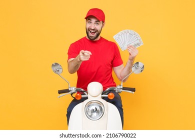 Delivery man in red cap t-shirt uniform driving moped motorbike scooter hold cash money isolated on yellow background studio Guy employee working courier Service quarantine pandemic covid-19 concept. - Shutterstock ID 2106790022