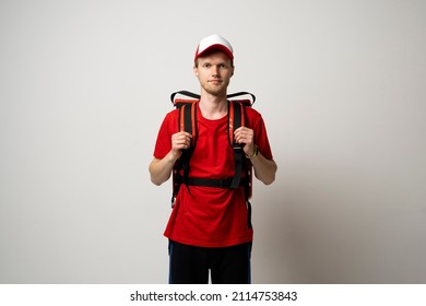 Delivery man in red t-shirt uniform work as dealer courier with a red thermal food bag isolated on white background studio. Food delivery service.
