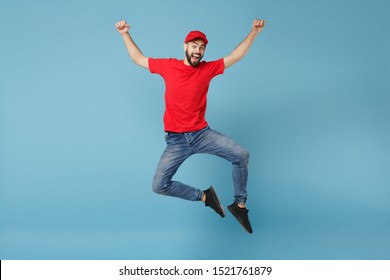 Delivery man in red uniform workwear isolated on blue wall background, studio portrait. Professional male employee in cap t-shirt print working as courier dealer. Service concept. Mock up copy space - Shutterstock ID 1521761879