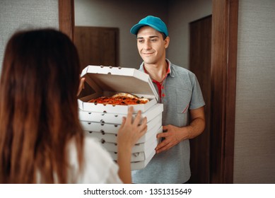 Delivery man shows pizza to customer at the door