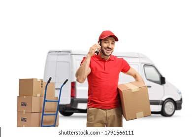 Delivery Man Talking On A Mobile Phone And Holding A Package In Front Of A Van Isolated On White Background