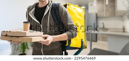 Delivery man with thermal backpack for food. Takeaway food delivery. Man delivering online food orders to customers with thermal bag, grocery deliver.