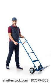 Delivery Man In Uniform With Empty Hand Truck Isolated On White