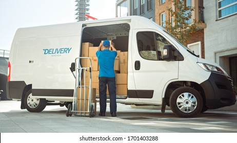 Delivery Man Uses Hand Truck Trolley Full of Cardboard Boxes and Packages, Loads Parcels into Truck / Van. Professional Courier / Loader helping you Move, Delivering Your Purchased Items Efficiently