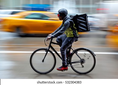 delivery on the bike in traffic on the city roadway  motion blur