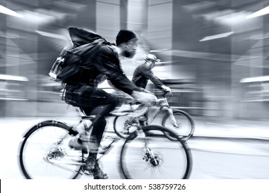 Delivery On The Bike In Traffic On The City Roadway Motion Blur In Blue Tonality