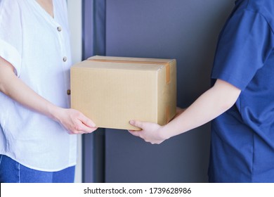 Delivery Person And Cardboard Box