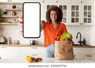 Delivery Service. Happy Black Female With Grocery Bag Showing Big Blank Smartphone With White Screen At Camera, Smiling African American Woman Recommending Mobile App Or Website, Mockup - Shutterstock ID 2310519721