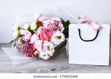 Delivery Service Packing Bouquet Flowers Pink White Background Gift Shipping. Beautiful Romantic Composition With Flowers. St. Valentines Day Background. Eco Bag Present. Mockup Copy Space. Holiday