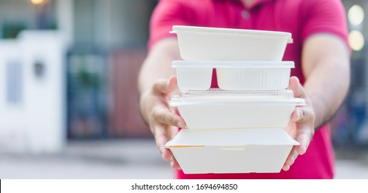 Delivery Service,Takeaway, Food Delivery And Stay At Home Safe Lives From Covid19 Coronavirus.Rider Deliveryman Holding Go Box Food Takeaway.Delivering Food In City.Delivery Food Service From Home.