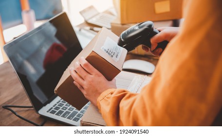 Delivery Staff Scanning Cardboard Box With Barcode Scanner To Check Products For Customers