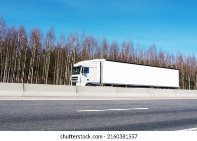 Delivery Truck With Long Empty Banner For Mockup Drives On Highway. Transportation Logistic Concept.