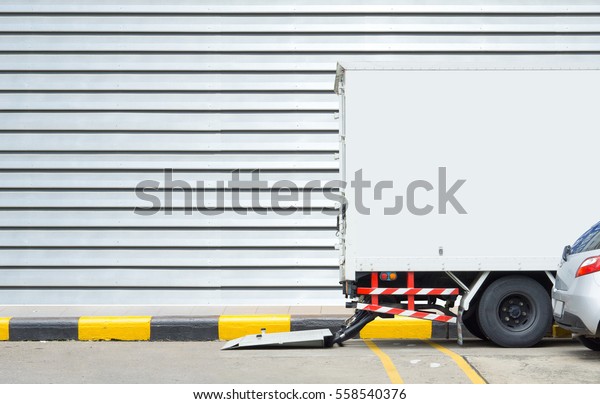 Delivery truck and transportation car concept -\
Delivery truck parking for delivery a parcel to receiver on\
footpath and copyspace