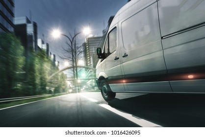 Delivery Van Drives In Illuminated City