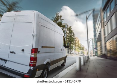 Delivery van drives through a city in the day
