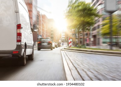 Delivery Van Driving In The City At Sunset