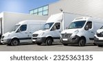 delivery white vans in service van fleet of cargo trucks courier and cars in front of the entrance of a warehouse distribution logistic society