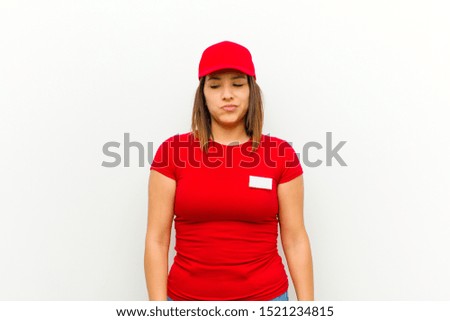 delivery woman looking goofy and funny with a silly cross-eyed expression, joking and fooling around against white background