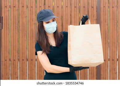 Delivery Woman Wearing Face Mask Holding Package Bag. Fast Food Worker Holding Takeaway Food  In Paper Bag 
