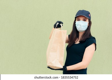 Delivery Woman Wearing Face Mask Holding Package Bag. Fast Food Worker Holding Takeaway Food  In Paper Bag 
