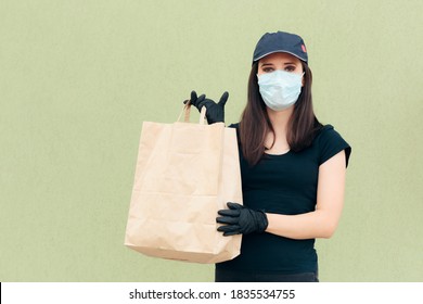 Delivery Woman Wearing Face Mask Holding Package Bag. Fast Food Worker Holding Takeaway Food  In Paper Bag 
