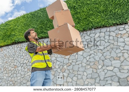 Delivery worker dropping a stack of packages, symbolizing the challenges, effort, and occasional mishaps involved in last-mile delivery and e-commerce logistics