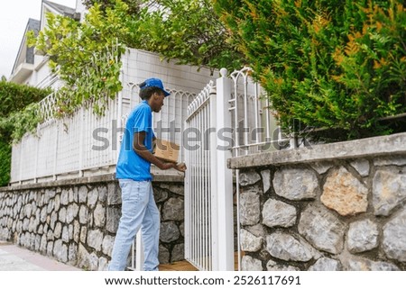 A delivery worker knocks on a gate while holding a package, ready to deliver. Concept of reliable and prompt parcel delivery service.