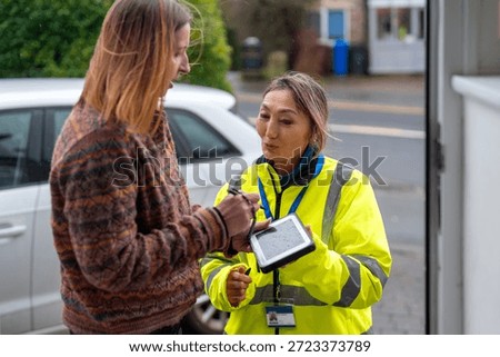 Delivery worker talks with customer to complete a service request in a residential area
