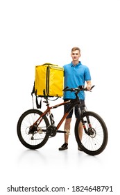 Deliveryman With Bicycle Isolated On White Studio Background. Contacless Service During Quarantine. Man Delivers Food During Isolation. Safety. Professional Occupation. Copyspace For Ad.